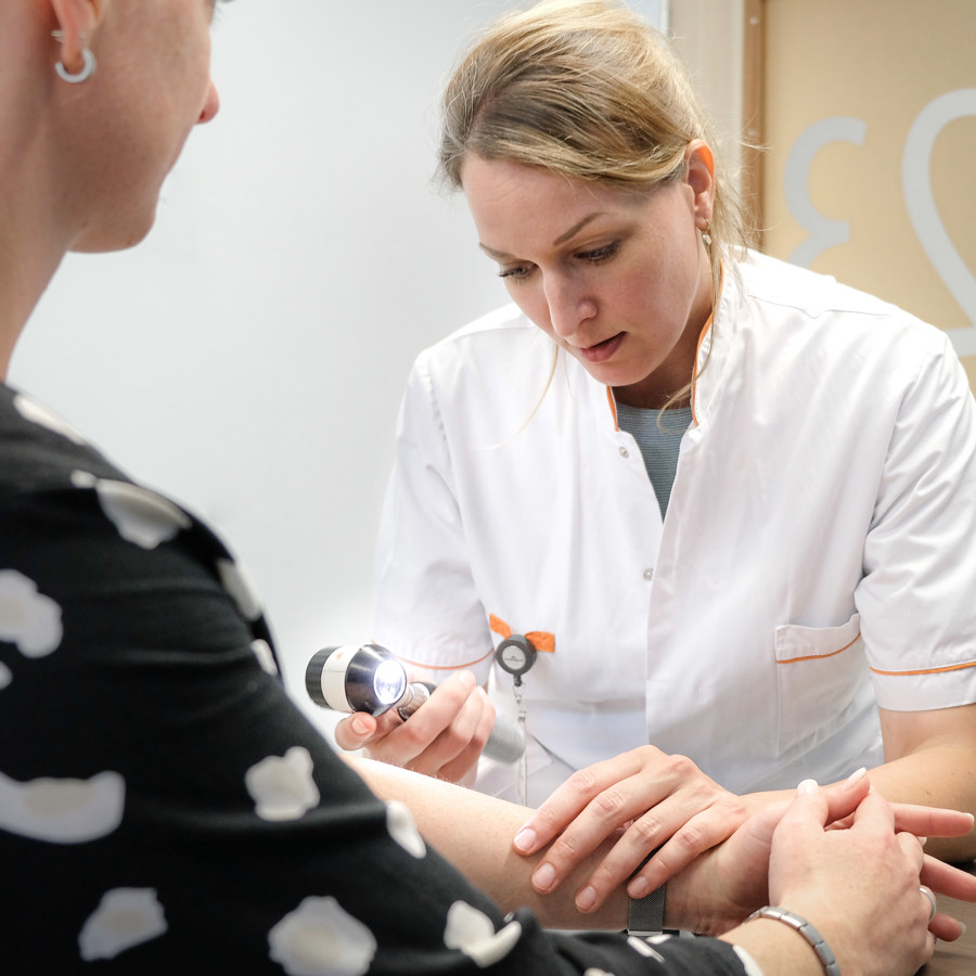 dermatoloog onderzoekt patiënt dermatoloog onderzoekt patiënt