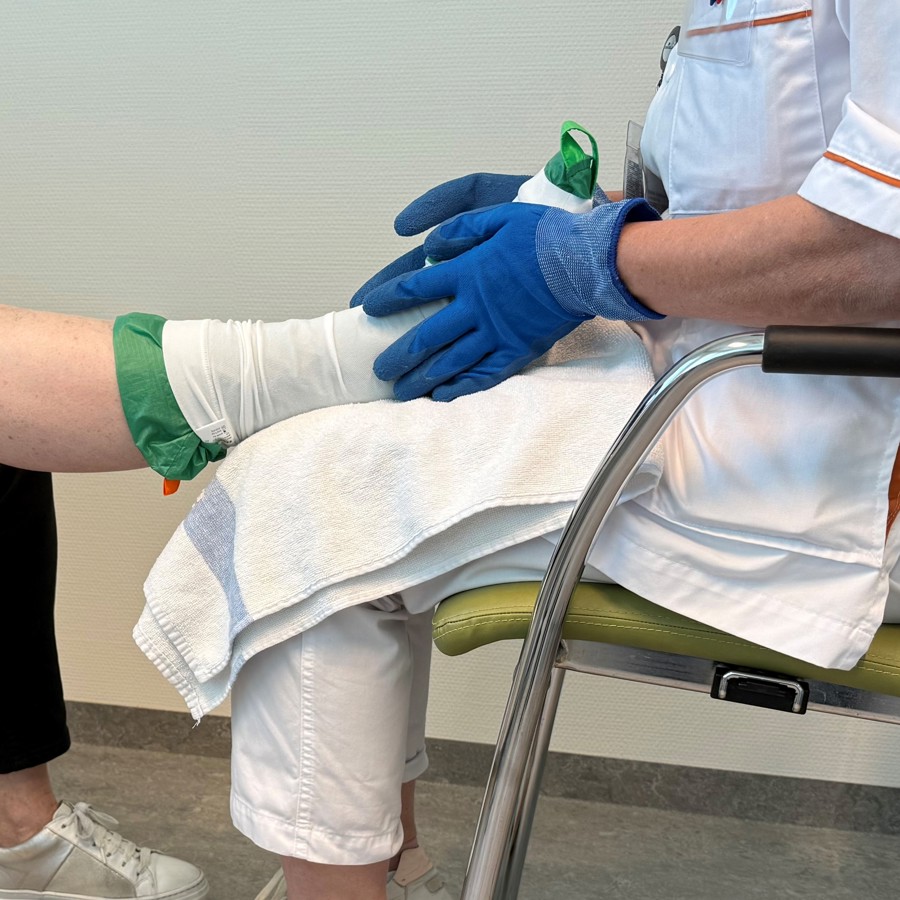 Patiënt leert steunkousen aan te trekken